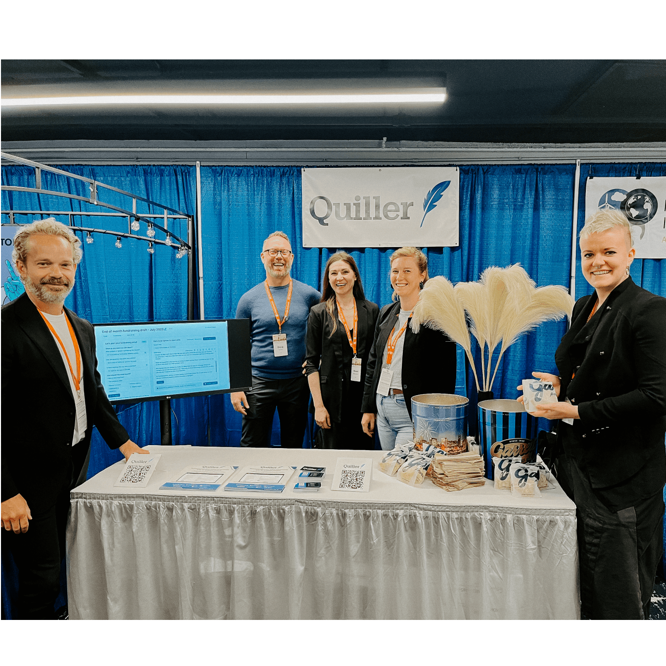 Photograph of five Quiller team members at a Quiller booth at Netroots Nation conference during their public launch
